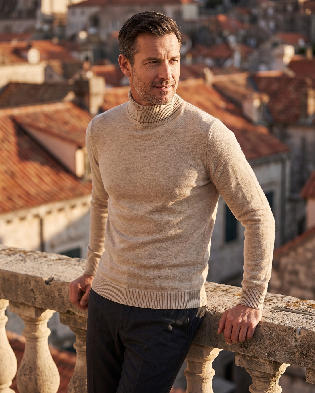 KEPT Men's Turtleneck Sweater - Gstaad in beige, worn on a terrace