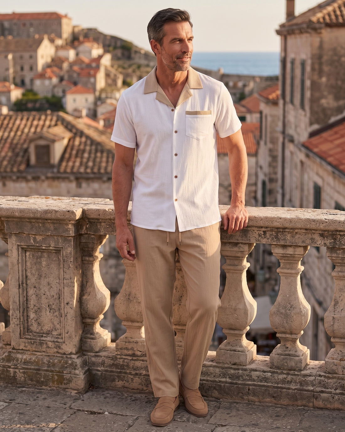 KEPT Men's 2-Piece Outfit Set - Sardinia in tan, worn on a terrace